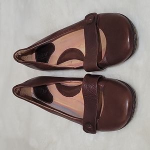 BORN flat “Mary Jane” style slip-on shoe in brown.